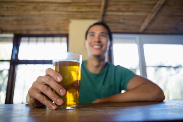 Happy man with beer glass looking away - Download Free Stock Photos Pikwizard.com