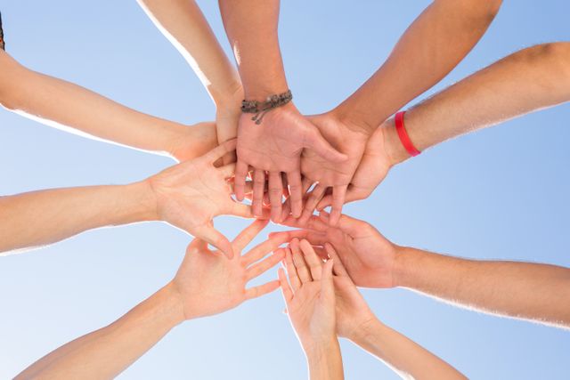 Directly below shot of friends stacking hands - Download Free Stock Photos Pikwizard.com