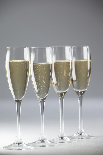 Four champagne flutes on white background - Download Free Stock Photos Pikwizard.com
