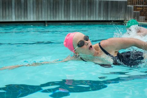 Mature woman swimming in pool - Download Free Stock Photos Pikwizard.com