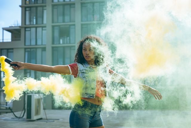 Young mixed race woman holding a smoke grenade - Download Free Stock Photos Pikwizard.com
