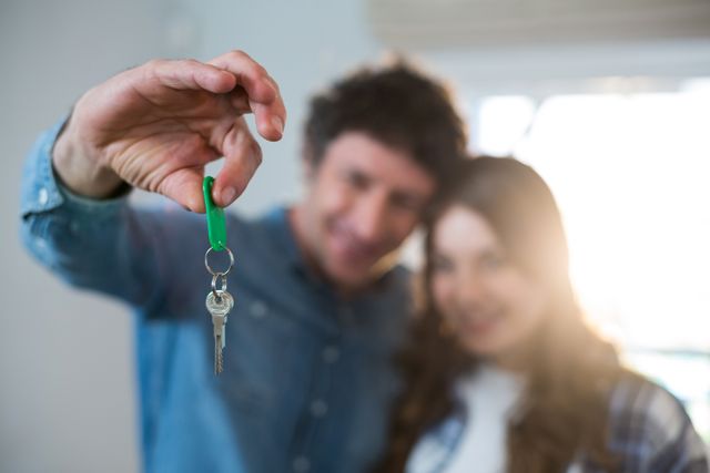 Couple holding the key of new home - Download Free Stock Photos Pikwizard.com