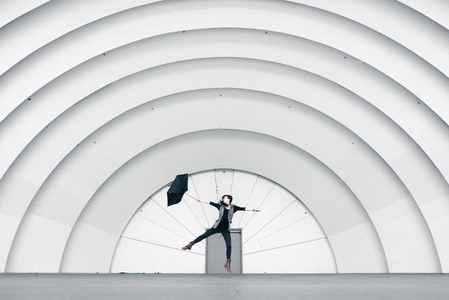 Girl Jumping While Holding Umbrella - Download Free Stock Photos Pikwizard.com