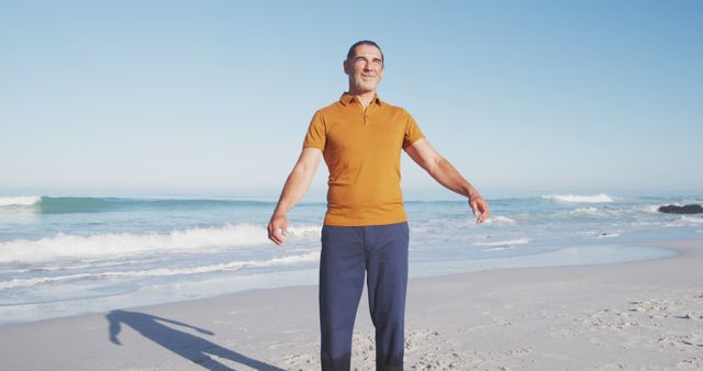 Happy senior caucasian man standing on beach - Download Free Stock Photos Pikwizard.com
