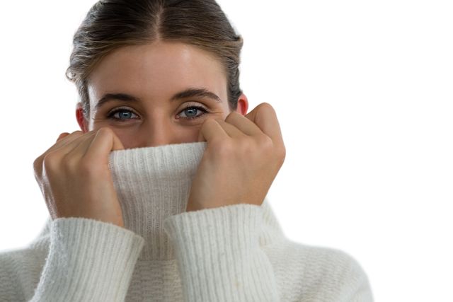 Portrait of woman covering face with turtleneck sweater - Download Free Stock Photos Pikwizard.com