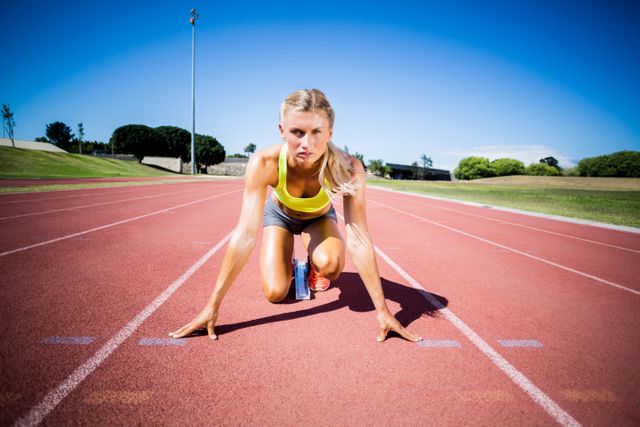 Female athlete ready to run on running track - Download Free Stock Photos Pikwizard.com