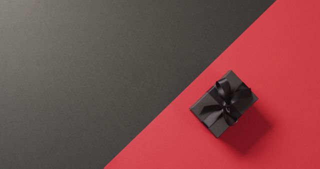 Overhead view of black gift box black ribbon on black and red background with copy space - Download Free Stock Photos Pikwizard.com
