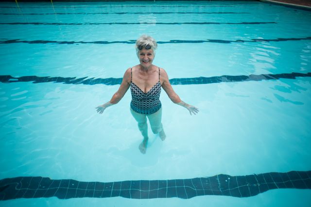 Happy senior woman swimming in pool - Download Free Stock Photos Pikwizard.com