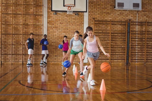 High school kids practicing football using cones for dribbling drill - Download Free Stock Photos Pikwizard.com