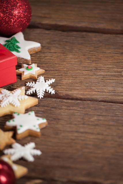 Cookies and christmas decorations on wooden table during christmas tree