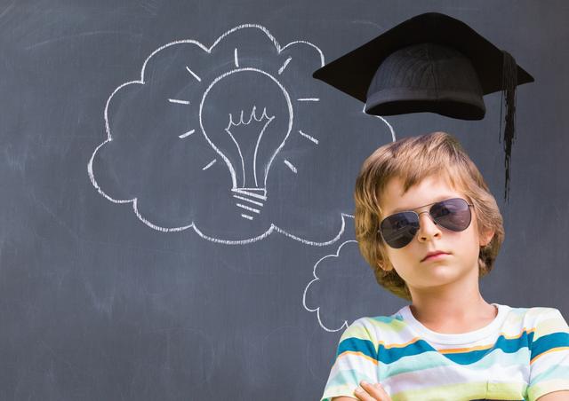 Boy with graduation cap against light bulb on blackboard - Download Free Stock Photos Pikwizard.com