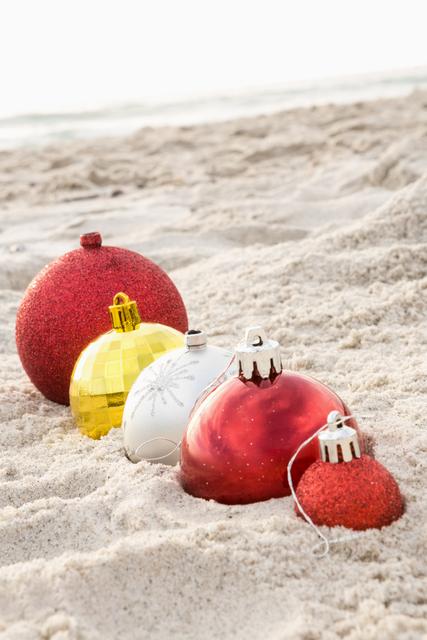 Christmas baubles arranged on the sand - Download Free Stock Photos Pikwizard.com