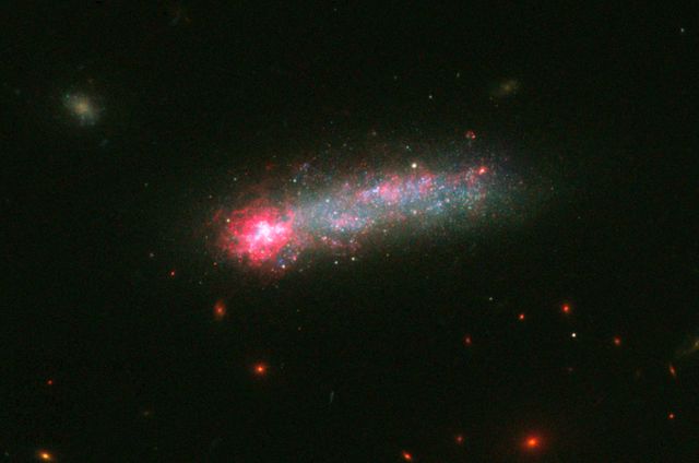 a galaxy with a bright red spot - Download Free Stock Photos Pikwizard.com