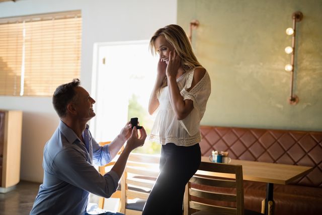 Man giving engagement ring to surprised woman - Download Free Stock Photos Pikwizard.com