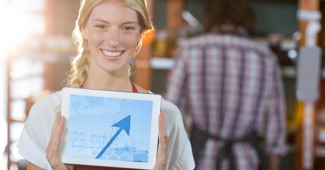 Happy woman holding digital tablet displaying arrow sign - Download Free Stock Photos Pikwizard.com