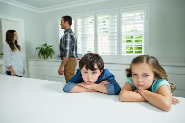 Sad siblings listening their parents having an argument at home - Download Free Stock Photos Pikwizard.com