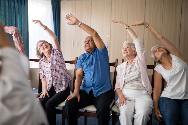 Smiling senior people stretching with female doctor - Download Free Stock Photos Pikwizard.com