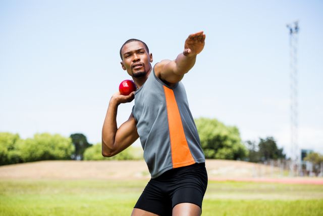 Male athlete about to throw shot put ball - Download Free Stock Photos Pikwizard.com