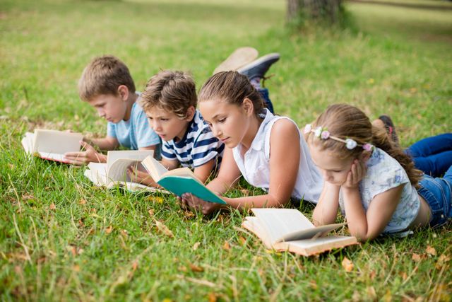 Kids lying on grass and reading books - Download Free Stock Photos Pikwizard.com