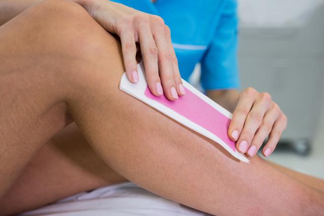 Woman getting her leg hair removed - Download Free Stock Photos Pikwizard.com