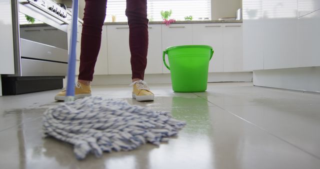 Caucasian woman cleaning floor with mop and bucket of water at home - Download Free Stock Photos Pikwizard.com