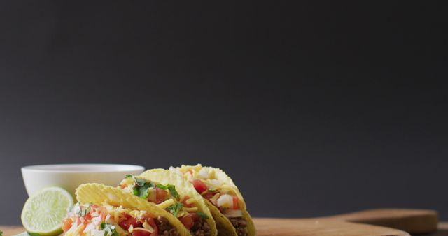 Image of freshly prepared tacos and bowl with sauce lying on board on grey background. cuisine, cooking, food preparing, taste and flavour concept.