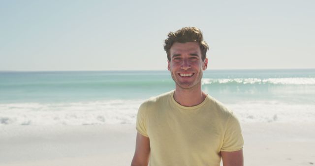 Portrait of caucasan smiling man standing on beach - Download Free Stock Photos Pikwizard.com