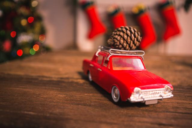 Toy car with pine cone on wooden table - Download Free Stock Photos Pikwizard.com
