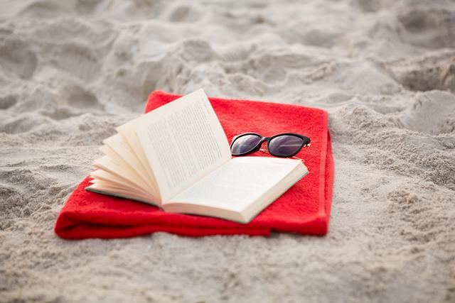 Open book and sunglasses kept on red napkin - Download Free Stock Photos Pikwizard.com
