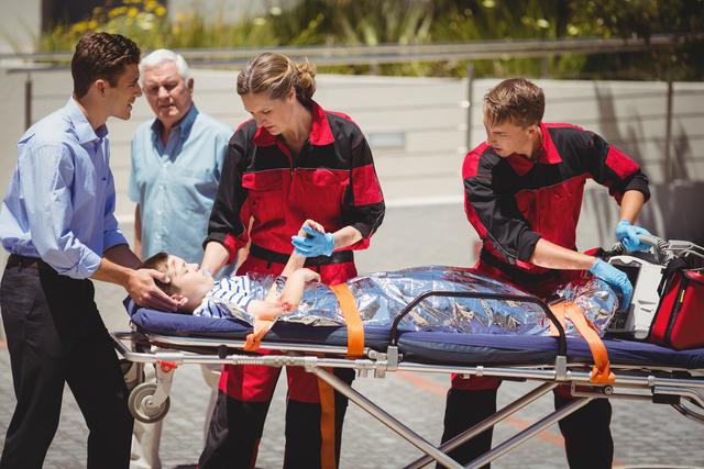 Paramedics examining injured boy - Download Free Stock Photos Pikwizard.com