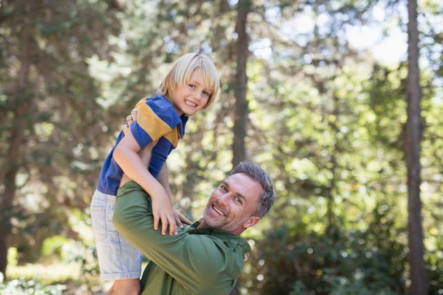 Portrait of playful father lifting up son  - Download Free Stock Photos Pikwizard.com
