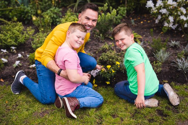 Portrait of caucasian father and two sons gardening together in the garden - Download Free Stock Photos Pikwizard.com