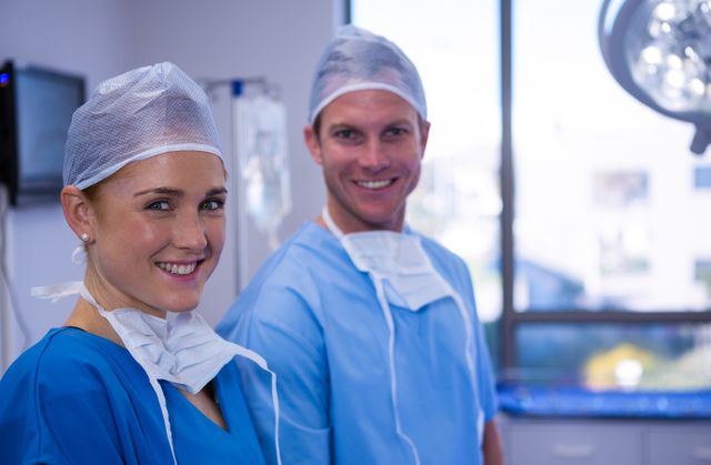 Portrait of male and female nurse smiling in operation theater - Download Free Stock Photos Pikwizard.com
