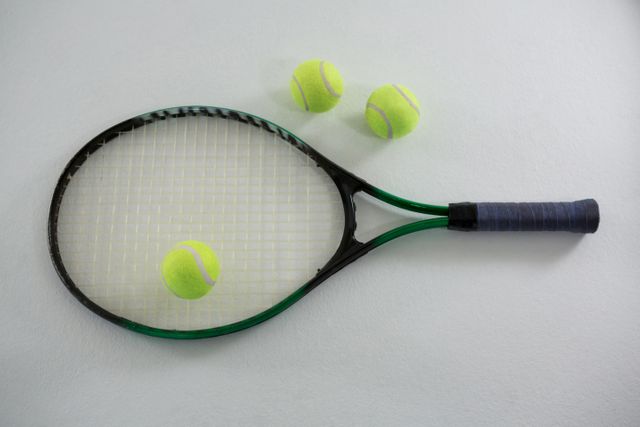 Overhead view of tennis balls with racket - Download Free Stock Photos Pikwizard.com