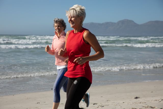 Two senior woman running on the beach - Download Free Stock Photos Pikwizard.com