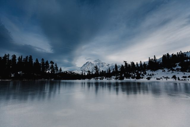 Landscape of Blue White Cloudy Sky Above Semi-frozen Lake Bordered by Forest - Download Free Stock Photos Pikwizard.com