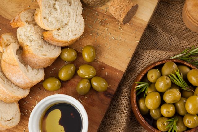 Close up of olives with bread on cutting board - Download Free Stock Photos Pikwizard.com