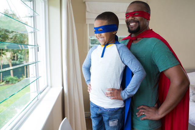 Father and son in superhero costume looking through window - Download Free Stock Photos Pikwizard.com
