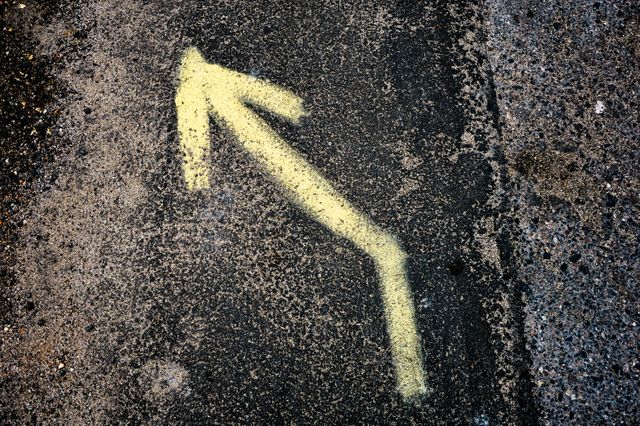 Yellow Left Arrow Sign on Black and Grey Surface - Download Free Stock Photos Pikwizard.com