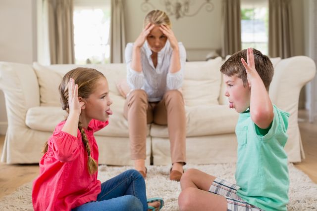 Upset woman sitting on sofa while siblings teasing each other at home