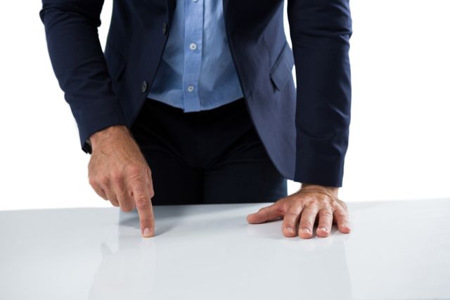 Businessman touching invisible screen on wooden table - Download Free Stock Photos Pikwizard.com