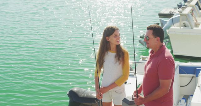 Reels of fishing rods onboard fishing boat on sunny day, with