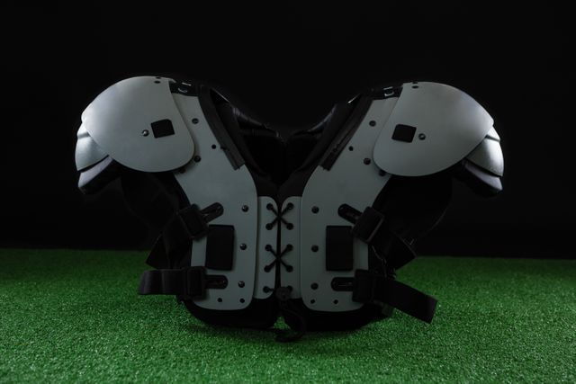 American football shoulder pads over artificial turf - Download Free Stock Photos Pikwizard.com