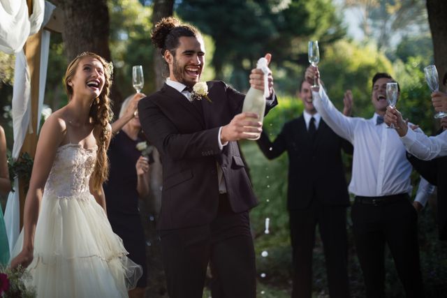  Groom opening champagne bottle at park - Download Free Stock Photos Pikwizard.com