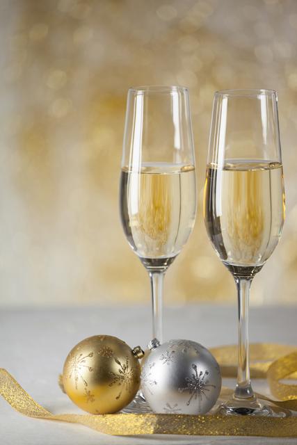 Two champagne flutes and Christmas decoration - Download Free Stock Photos Pikwizard.com