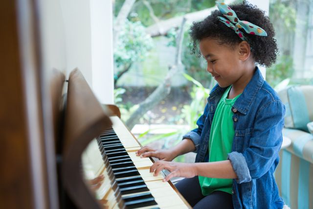 Adorable girl playing piano - Download Free Stock Photos Pikwizard.com