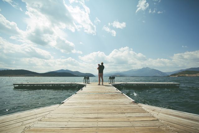 Person Standing on Brown Wooden Dock Under Clue Sky during Daytime - Download Free Stock Photos Pikwizard.com