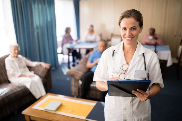 Smiling female doctor standing with file - Download Free Stock Photos Pikwizard.com
