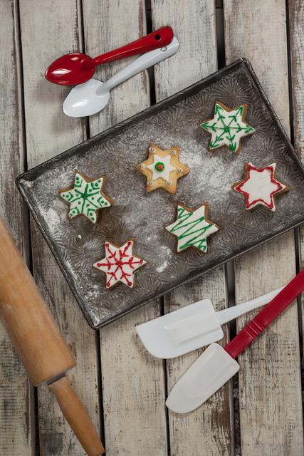 Spatula, spoon, rolling pin and tray with baked Christmas cookies - Download Free Stock Photos Pikwizard.com
