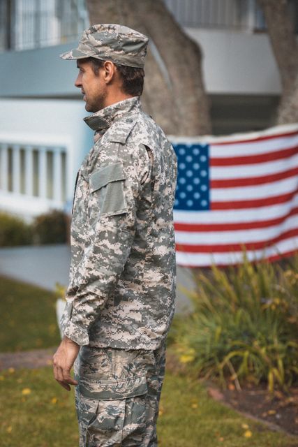 Portrait of african american soldier standing next to united states flag. soldier returning home to family.